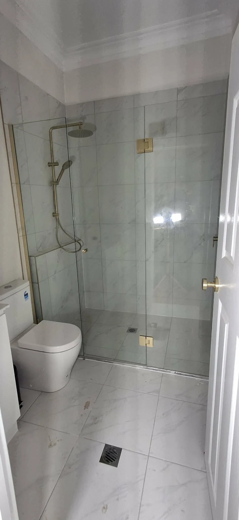 Completed bathroom with frameless shower